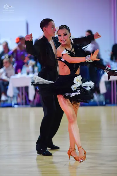 Dancesport competitor: Male dancer: black long-sleeved shirt and black trousers