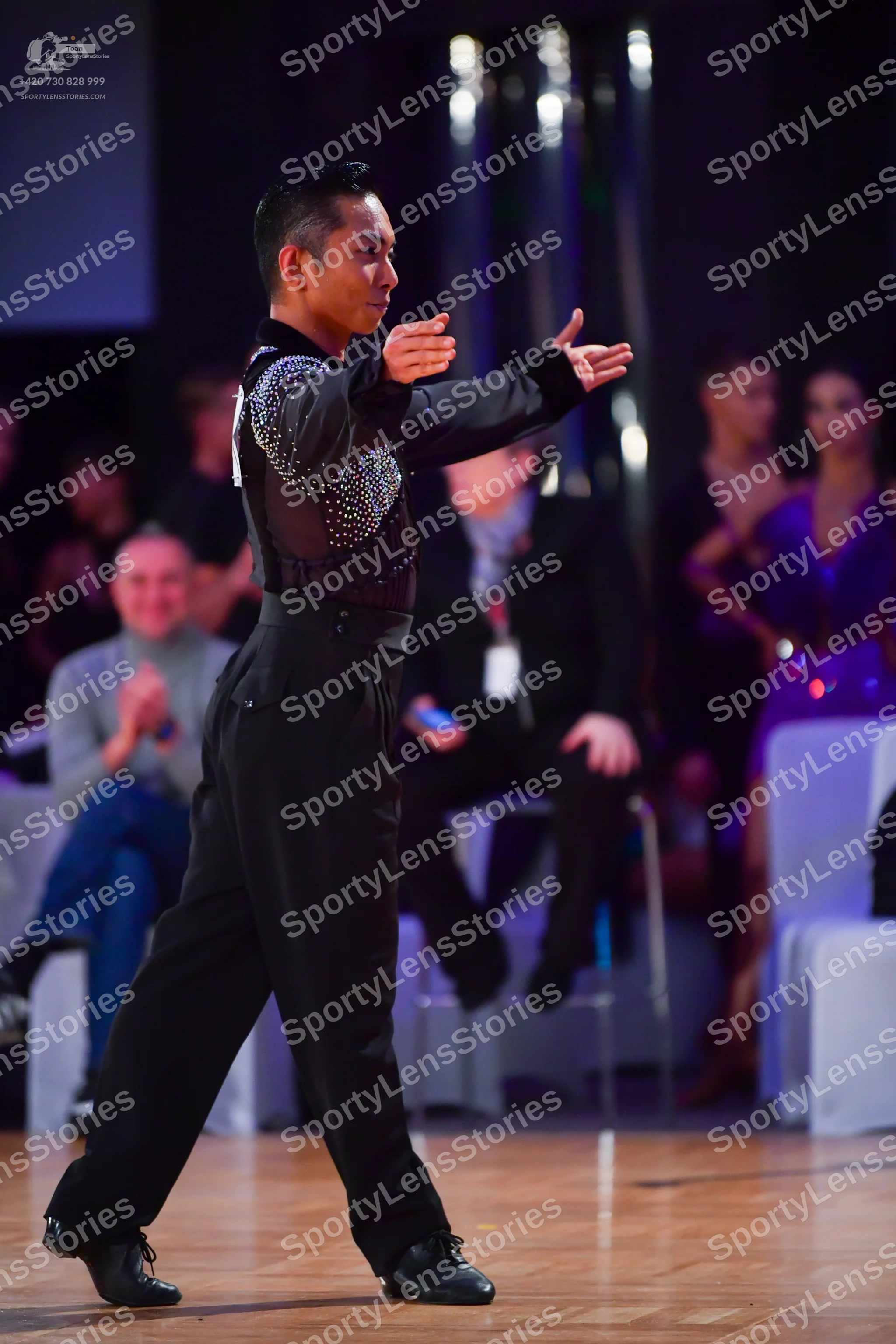 Dancesport competitor: Male dancer: black long-sleeve shirt with silver sequins on the chest and should