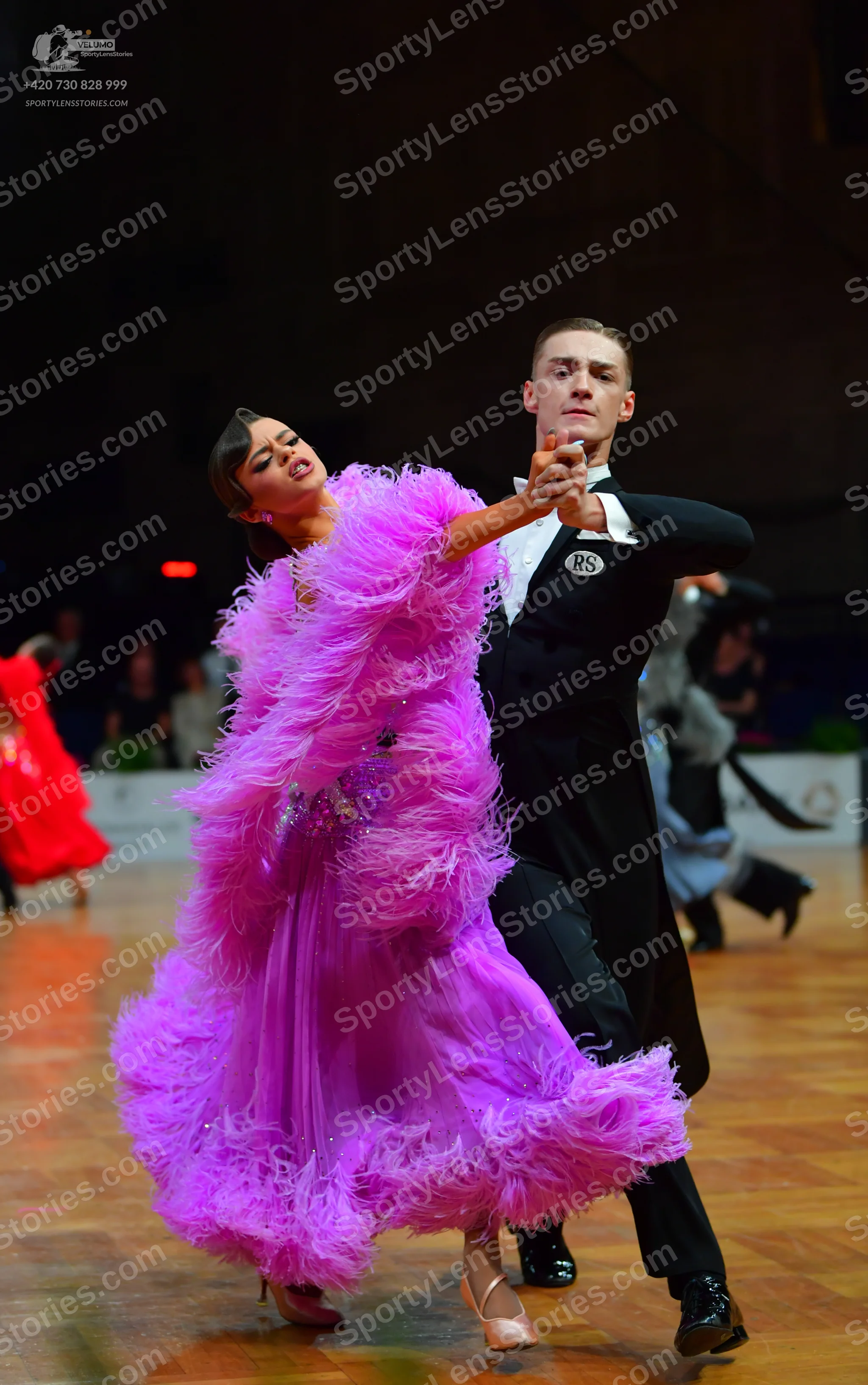Dancesport competitor: Female dancer: bright pink/magenta ballgown with voluminous pink feathers