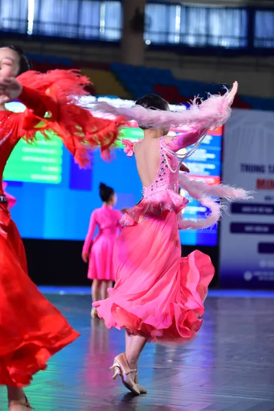 Dancesport competitor: ** Female: Pink, voluminous latin dress with a sweetheart neckline