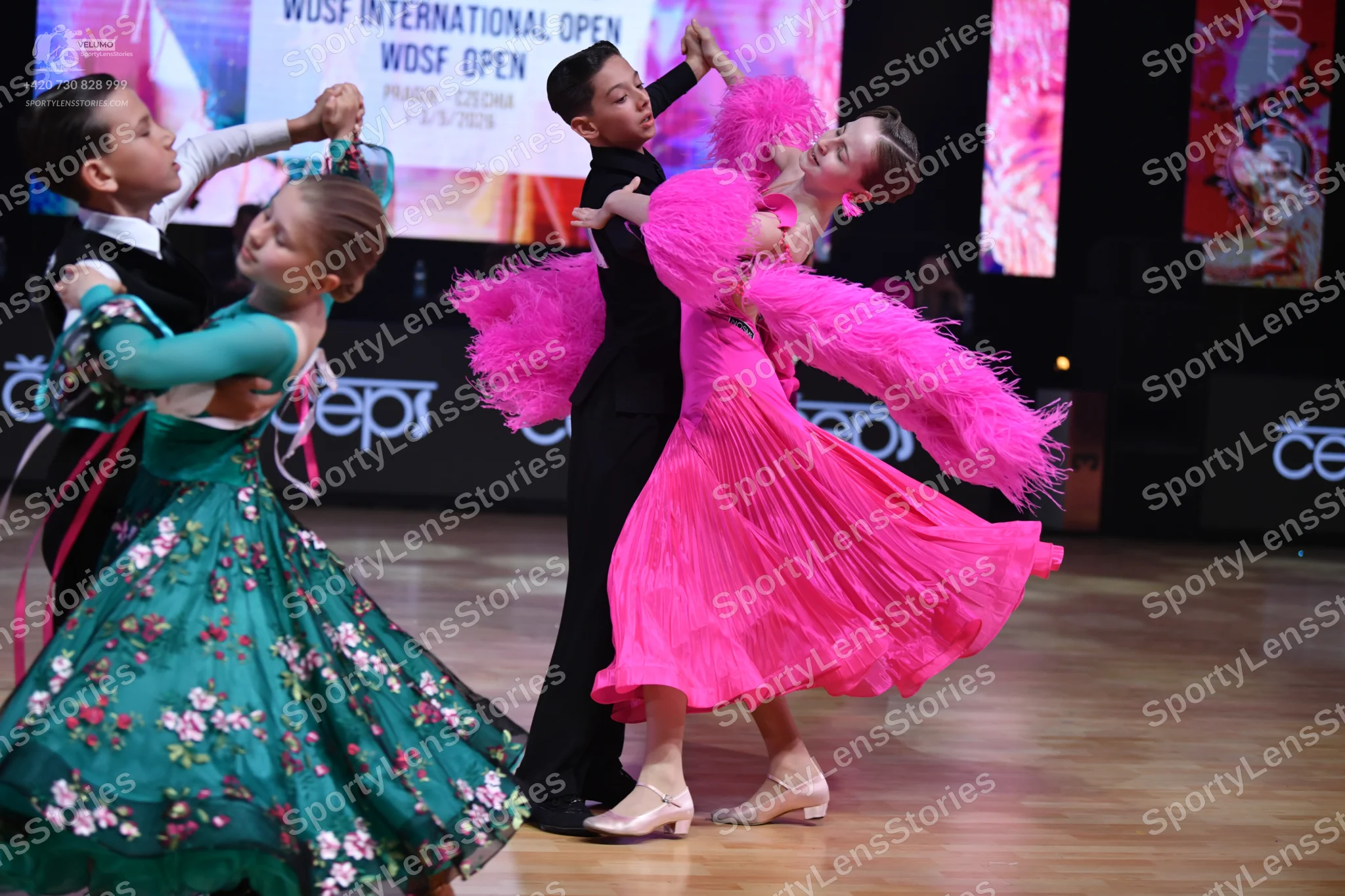 Dancesport competitor: Female dancer 1: teal ballgown with pink floral patterns and tulle fabric