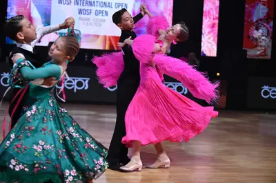 Dancesport competitor: Female dancer 1: teal ballgown with pink floral patterns and tulle fabric