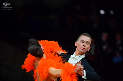 Dancesport competitor: Male dancer: black suit, white shirt, and white bow tie