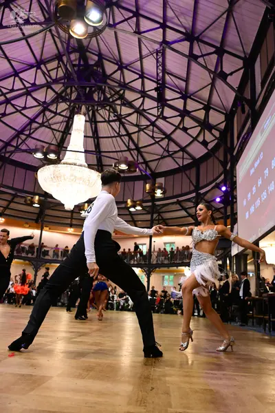 Dancesport competitor: Male dancer: white long-sleeved shirt and black trousers