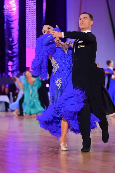 Dancesport competitor: Male dancer: black ballroom suit with black trousers and black dance shoes