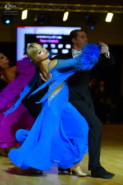 Dancesport competitor: Male dancer: black suit with a white shirt and a white bow tie