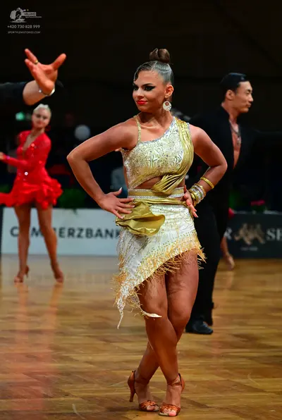 Dancesport competitor: Main female dancer: champagne-colored one-shoulder Latin dance dress with sequin
