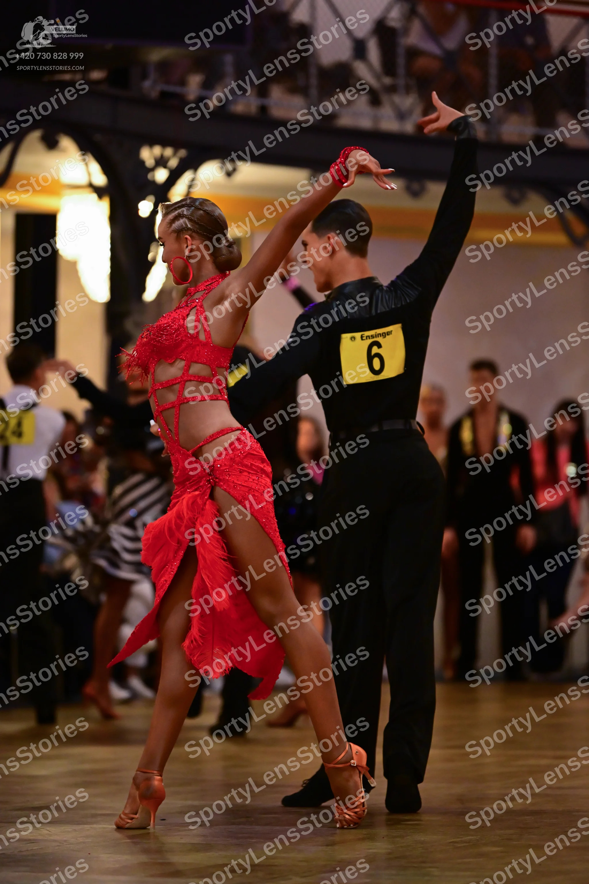 Dancesport competitor: Female dancer: red latin dress with lace, mesh, and cutouts