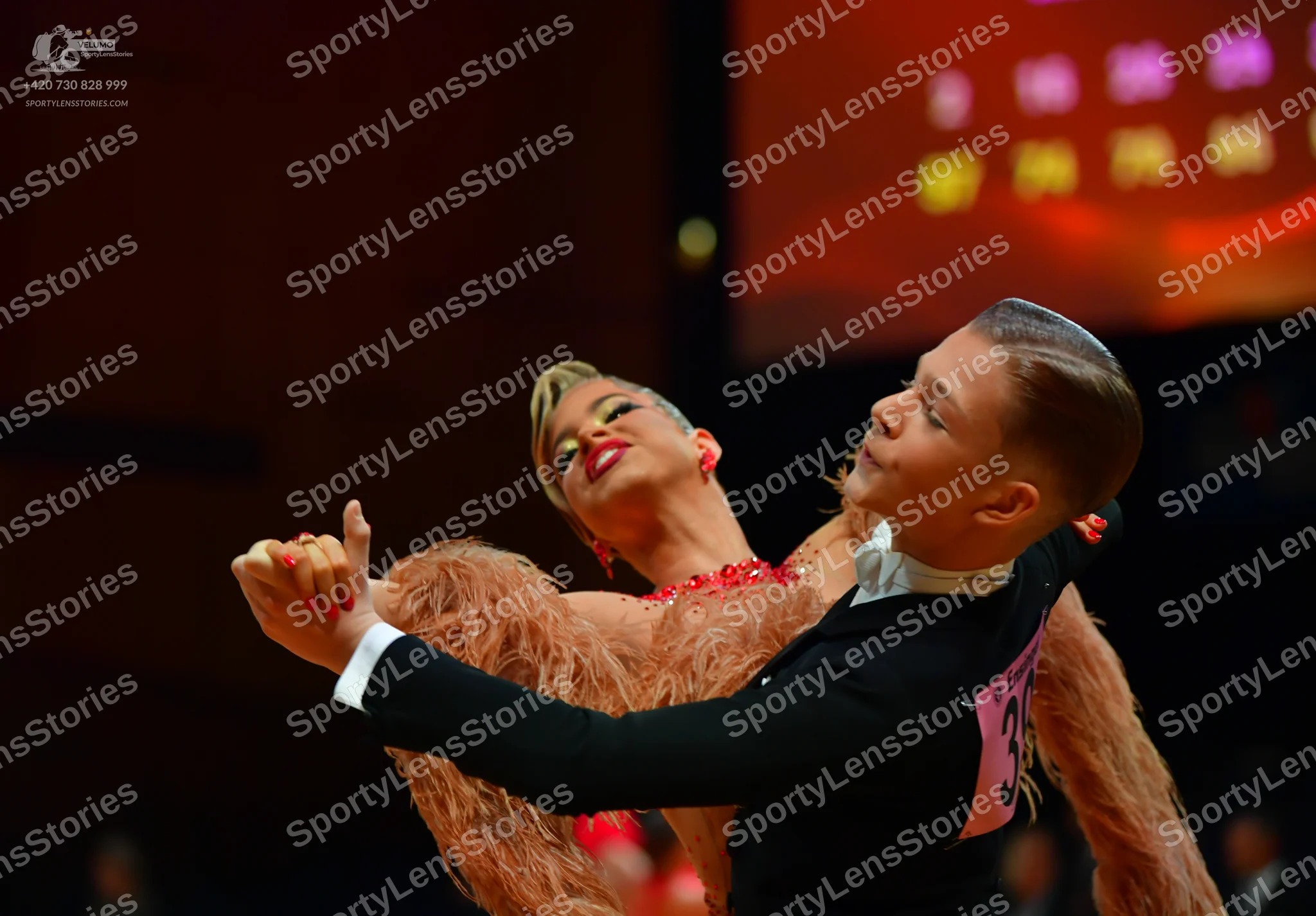 Dancesport competitor: Male dancer: black long-sleeved top with a white collar