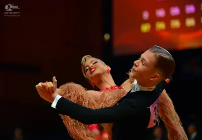 Dancesport competitor: Male dancer: black long-sleeved top with a white collar