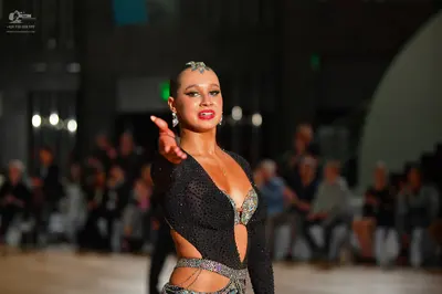 Dancesport competitor: Female dancer: black Latin dance bodysuit with silver/iridescent sequin/rhinesto