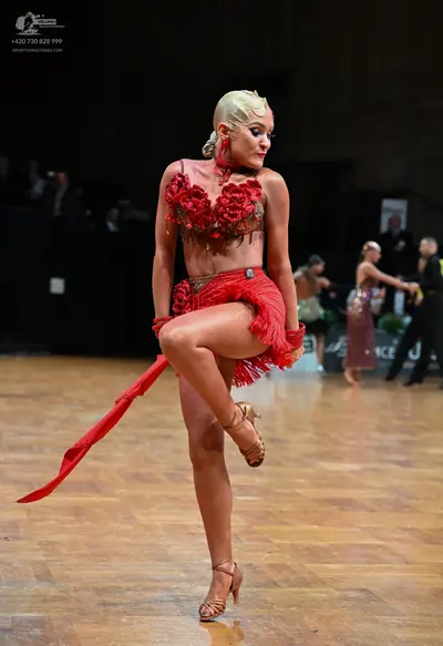 Dancesport competitor: Female dancer: red Latin dress with floral embellishments on the bodice and red 