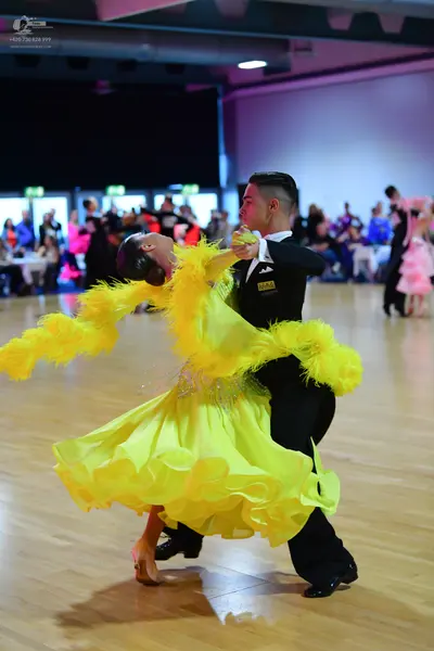 Dancesport competitor: Male dancer: black suit with a white shirt