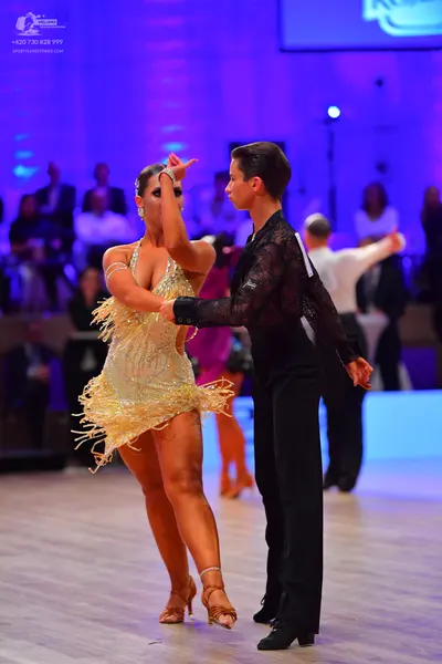 Dancesport competitor: Male dancer: black sheer long-sleeved shirt and black trousers