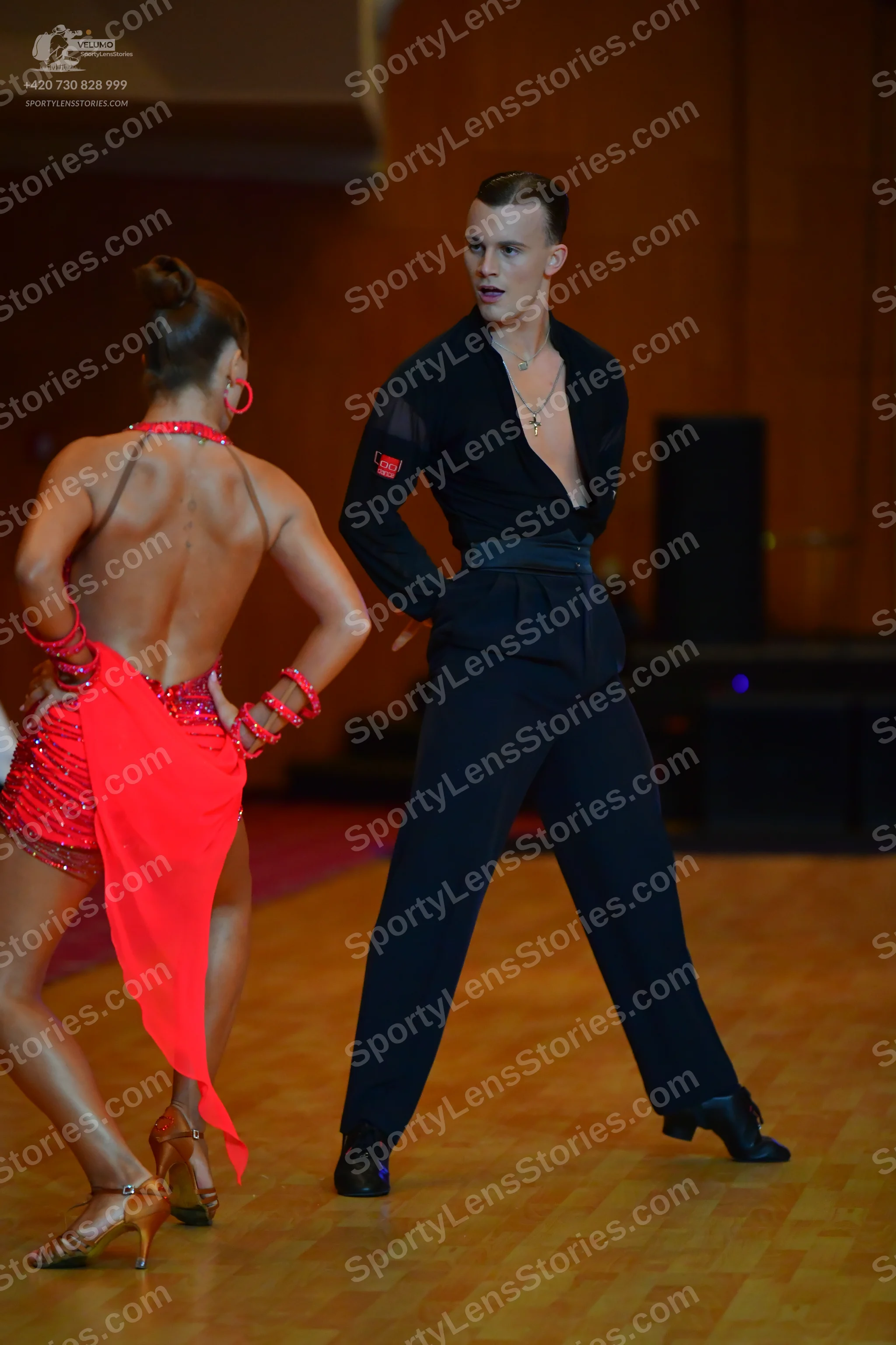 Dancesport competitor: Male dancer: black latin dance outfit featuring a sheer top with a wide waistban
