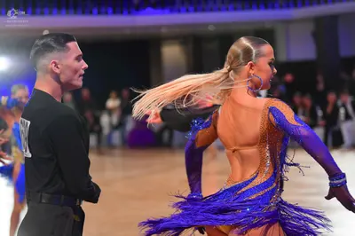 Dancesport competitor: Male dancer: black long-sleeved shirt and black trousers