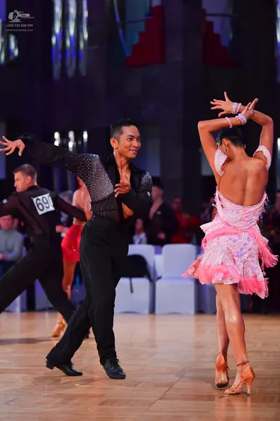 Dancesport competitor #691: Male dancer: black long-sleeved shirt with silver sequins, black trousers, and b