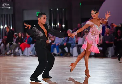 Dancesport competitor: Male dancer: black long-sleeved Latin dance shirt with sequins on the shoulder a