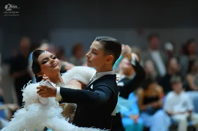Dancesport competitor: Male dancer: black suit with a white shirt