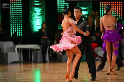 Dancesport competitor: Female dancer 1: pink latin dress with lace and sheer mesh