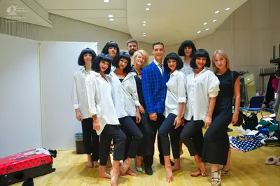 Dancesport competitor: Most female dancers: white long-sleeved button-down shirts and black cropped leg