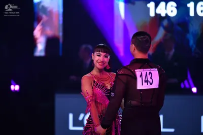 Dancesport competitor: Female dancer: pink Latin dress with fringe