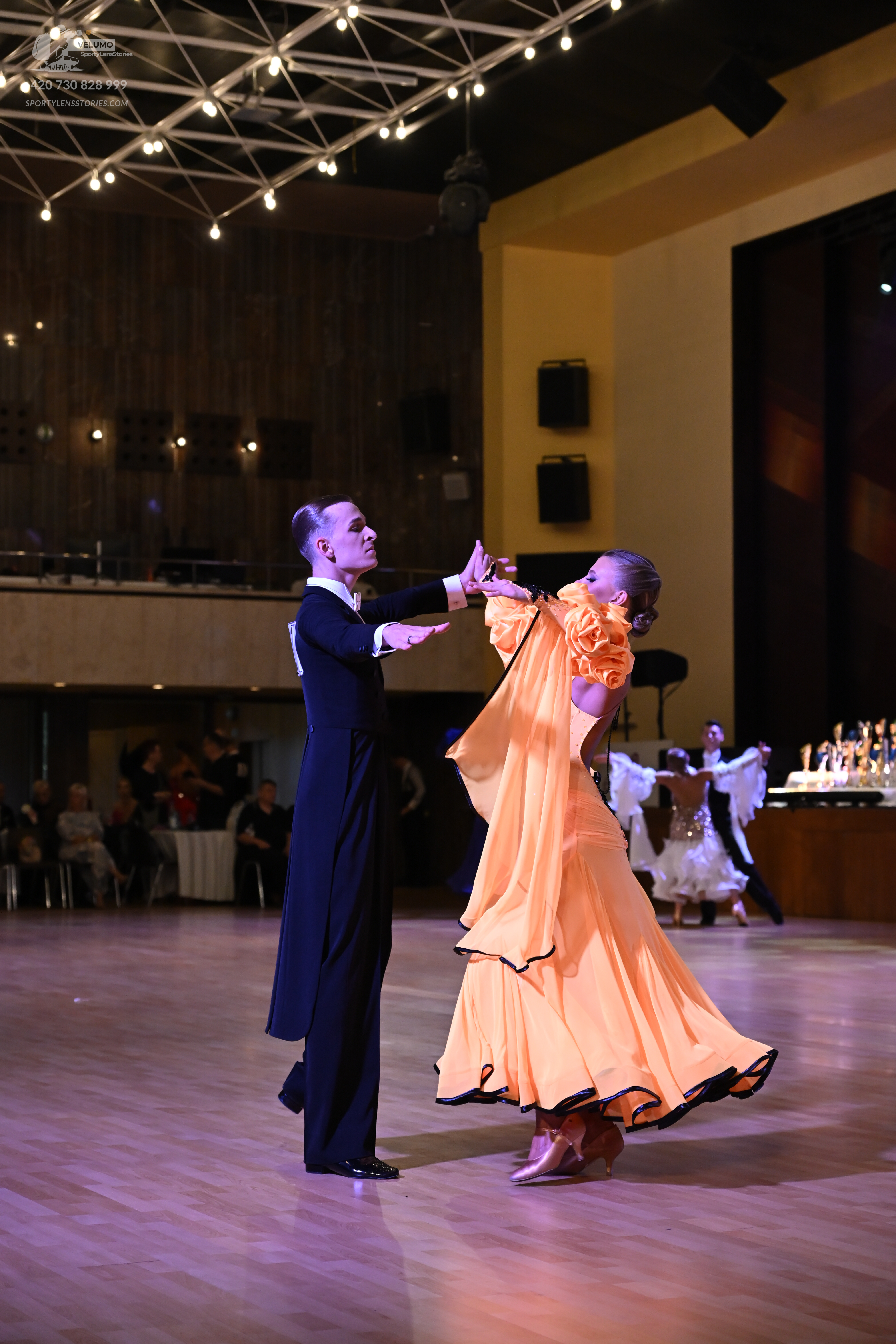 Dancesport competitor: ** Black tail suit with gold sequin lapels