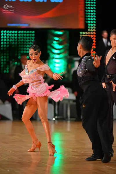 Dancesport competitor: Female dancer: light pink Latin dress with sequins, fringe, and cutouts