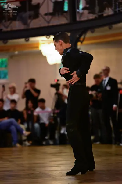 Dancesport competitor: Male dancer: black long-sleeve shirt and black trousers