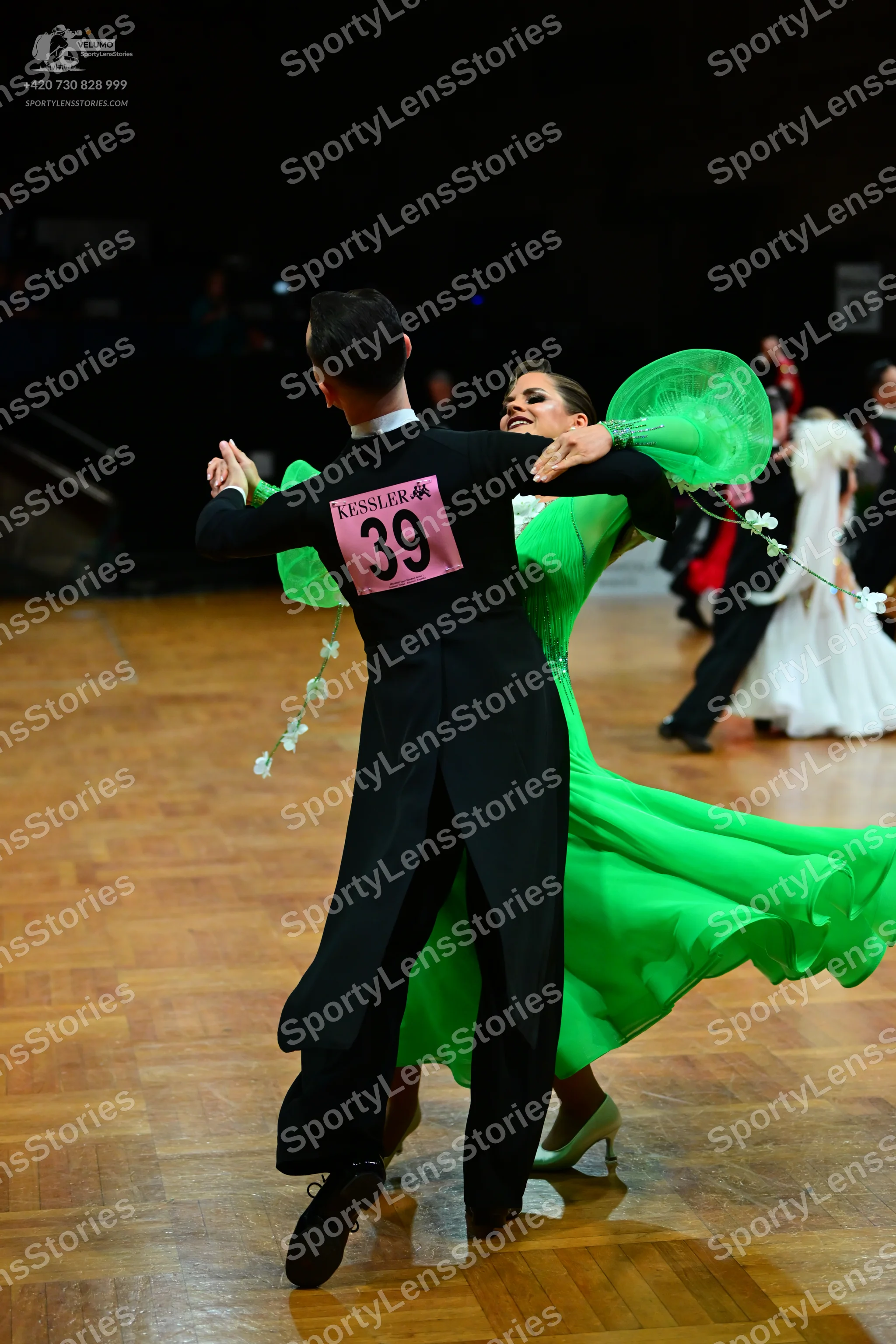 Dancesport competitor #39: Male dancer: black tailcoat with a white collar, black trousers, and black dance