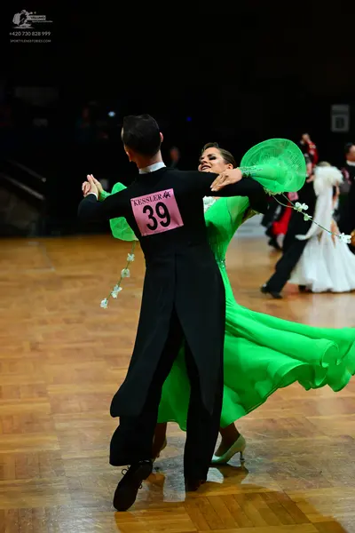 Dancesport competitor #39: Male dancer: black tailcoat with a white collar, black trousers, and black dance