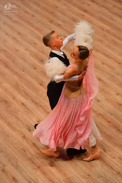 Dancesport competitor: Male dancer: black suit with white shirt
