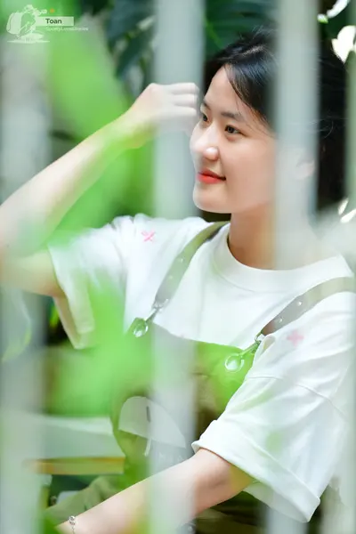 Dancesport competitor: The person is wearing a white short-sleeved t-shirt and green overalls