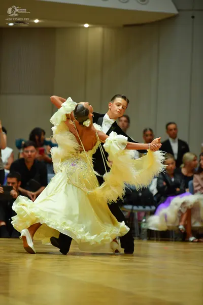Dancesport competitor: Male dancer: black suit with a white shirt and white bowtie