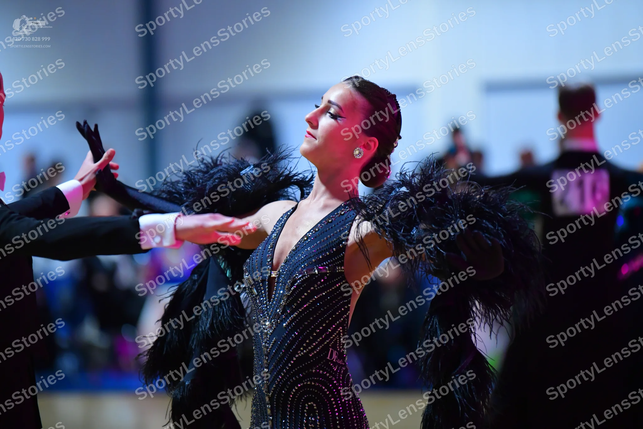 Dancesport competitor #216: Female dancer: dark (black or navy) latin dress with extensive sequin and rhines