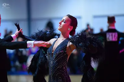 Dancesport competitor #216: Female dancer: dark (black or navy) latin dress with extensive sequin and rhines