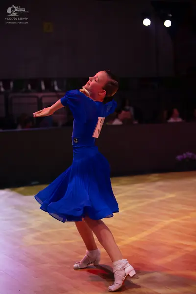Dancesport competitor: Female dancer: blue dress with short sleeves and a flared skirt
