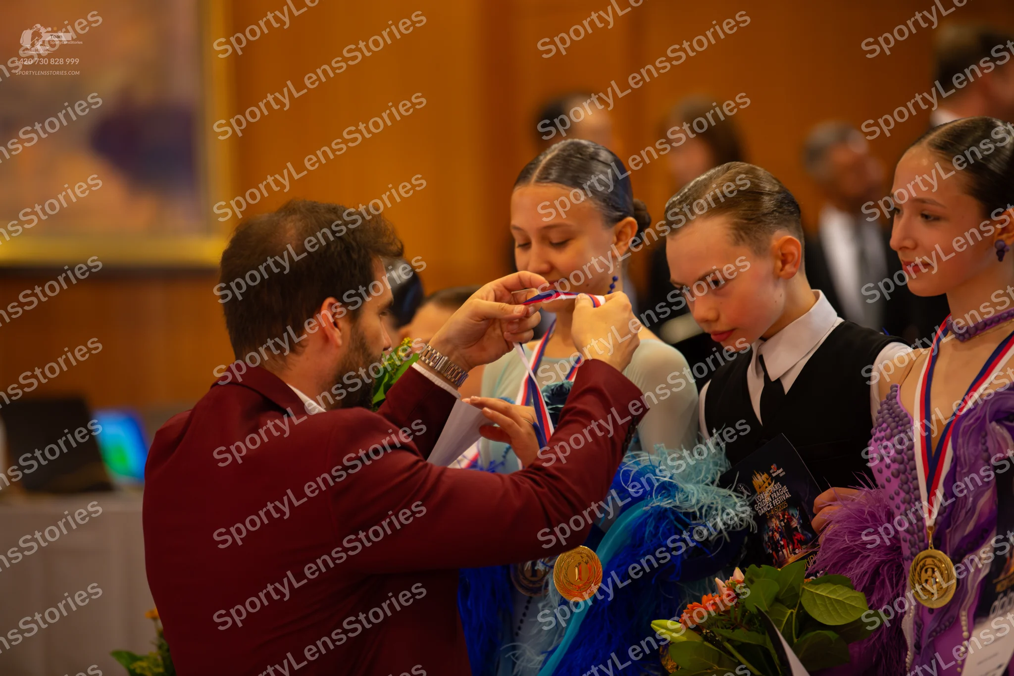 Dancesport competitor: Male dancer 1: maroon suit jacket