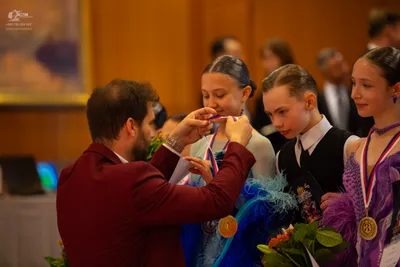Dancesport competitor: Male dancer 1: maroon suit jacket
