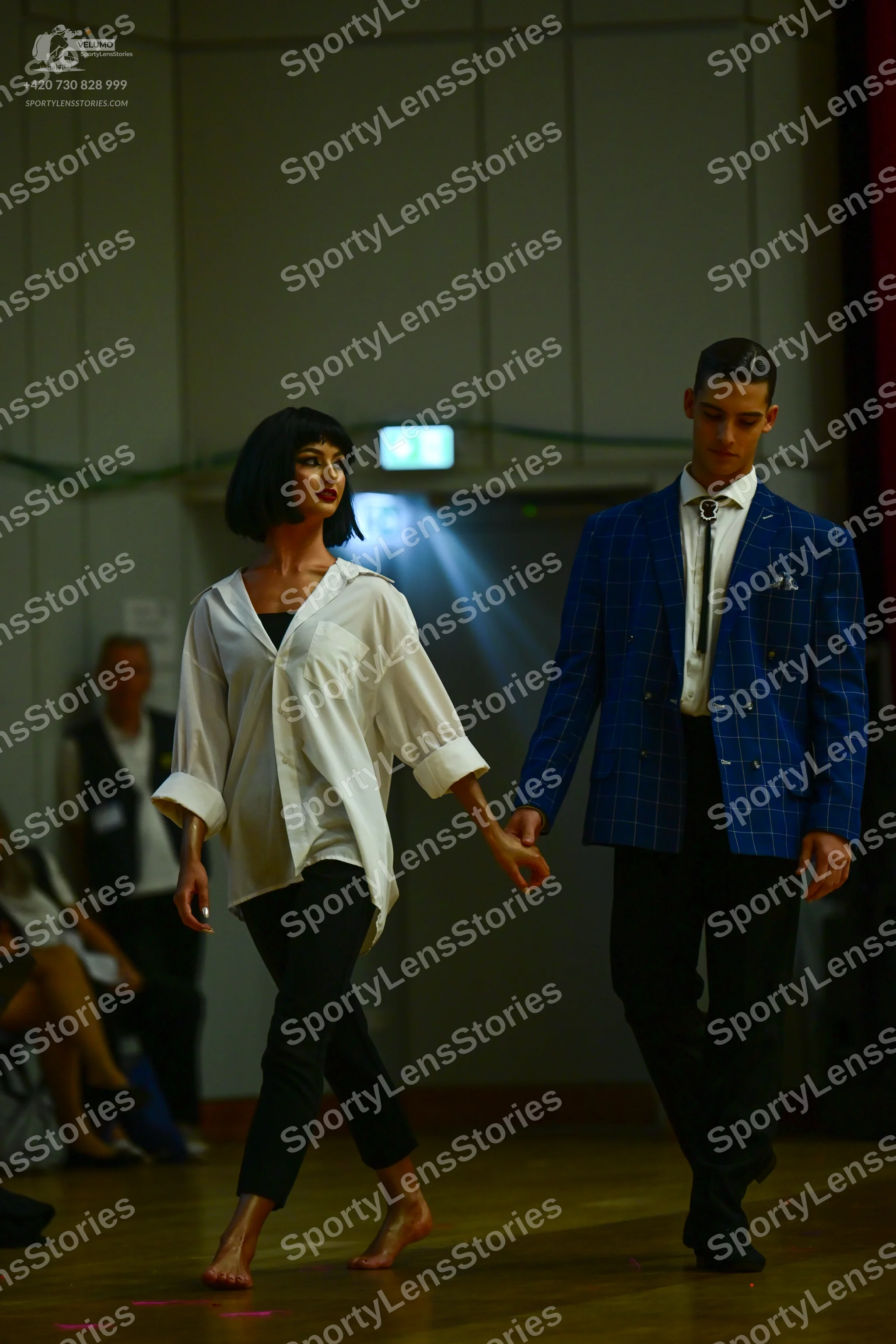 Dancesport competitor: Female dancer: oversized white button-down shirt with rolled-up sleeves and blac