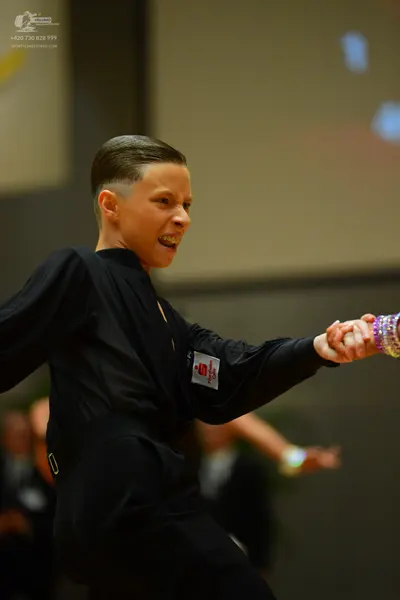 Dancesport competitor: Male dancer: black long-sleeved top and black trousers
