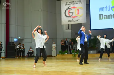 Dancesport competitor: Female dancers: white long-sleeved shirts and black pants