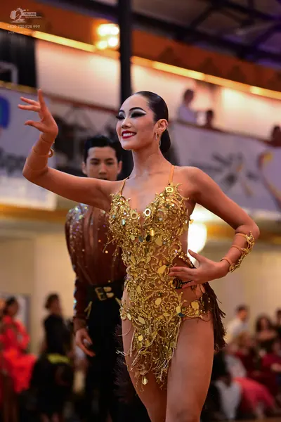 Dancesport competitor: Male dancer: bronze-colored shirt with a black waistband and black trousers