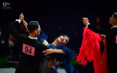 Dancesport competitor: Male dancer (left): black long-sleeved shirt with a white collar
