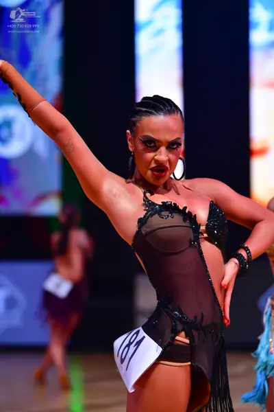 Dancesport competitor: Female dancer: black latin dress with sheer mesh panels and black sequin/beaded 