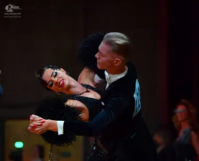 Dancesport competitor: Male dancer: black suit with a white shirt