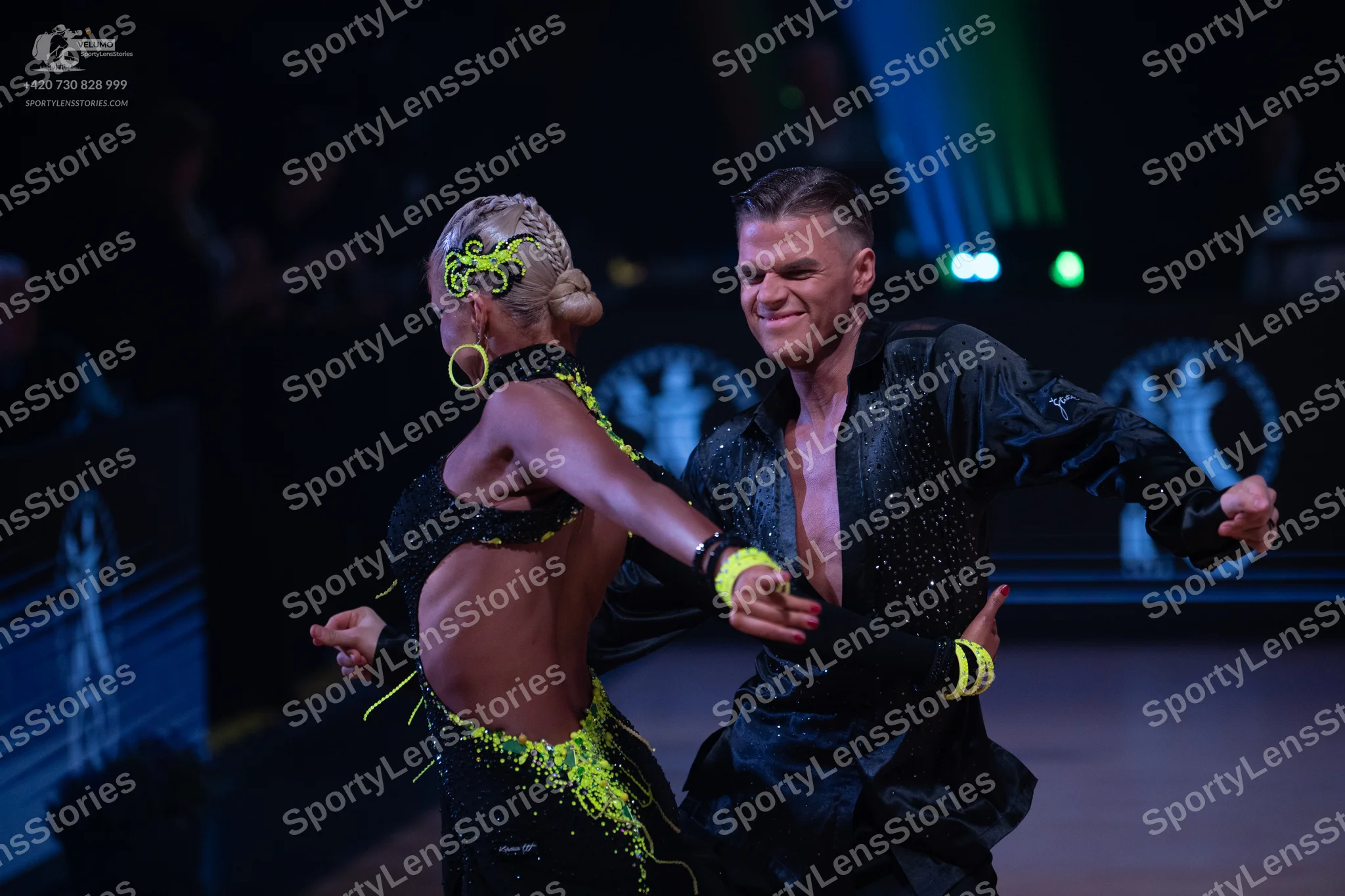 Dancesport competitor: Female dancer: black latin costume with neon yellow/lime green sequin and fringe