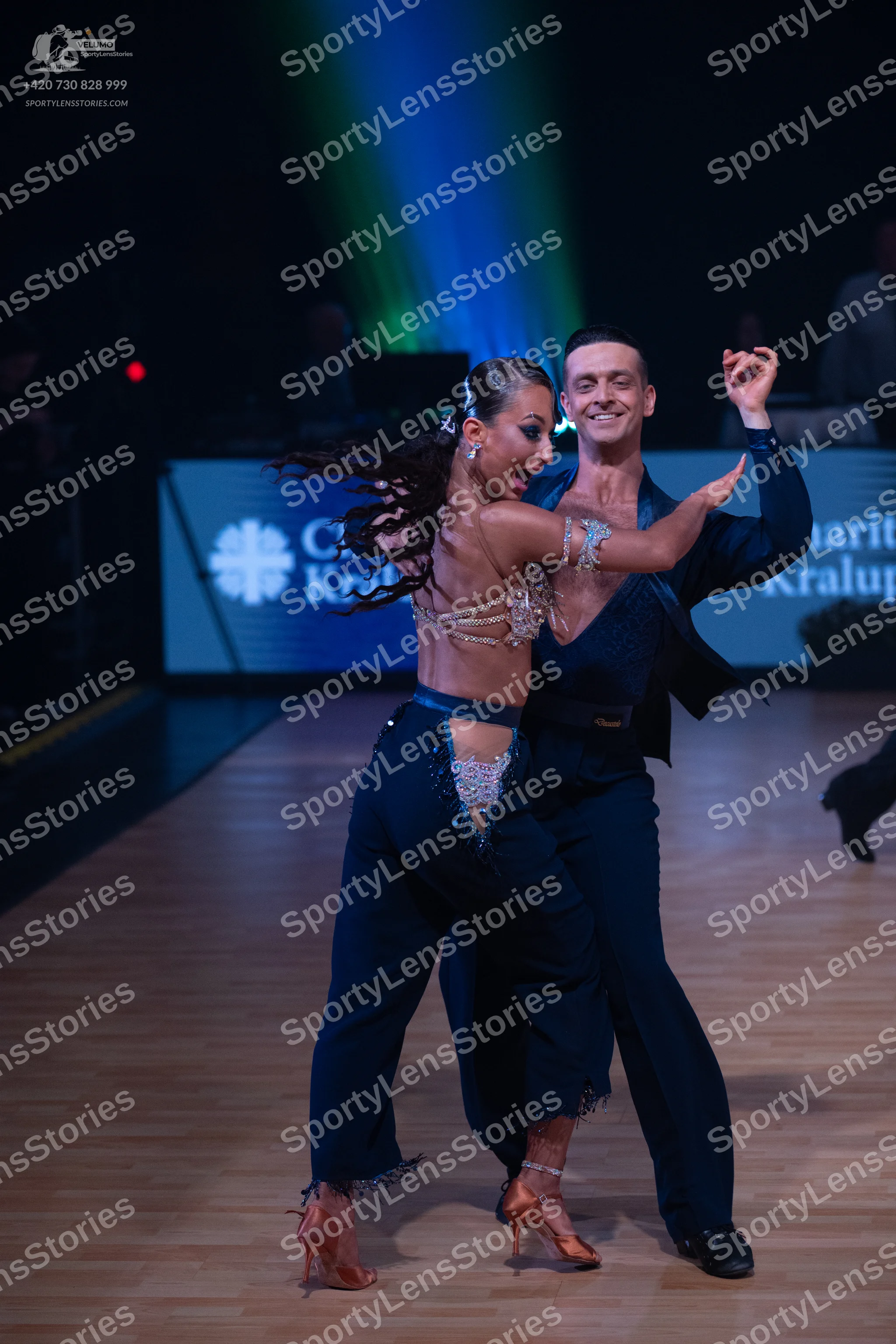 Dancesport competitor: Female dancer: Navy blue Latin dance outfit featuring a heavily embellished (rhi