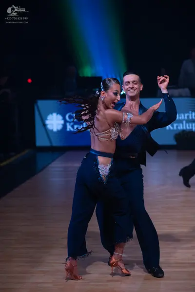 Dancesport competitor: Female dancer: Navy blue Latin dance outfit featuring a heavily embellished (rhi