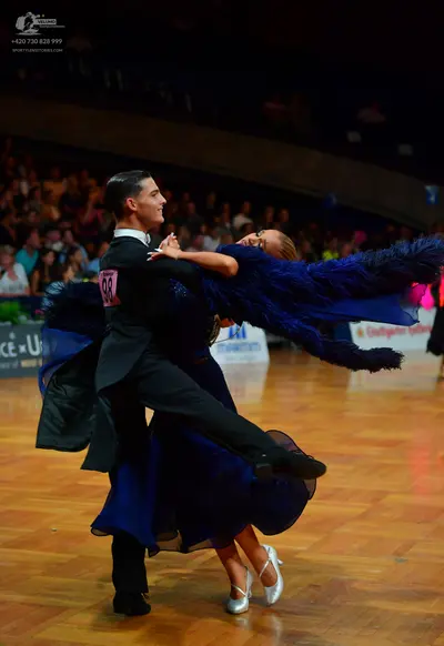 Dancesport competitor: Male dancer: black suit with a white shirt and black trousers